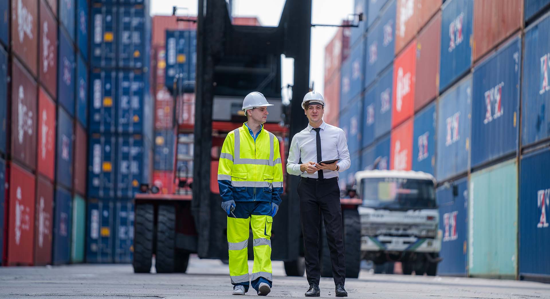 businesspeople-with-cargo-container-worker-check-g-2023-11-27-05-36-13-utc